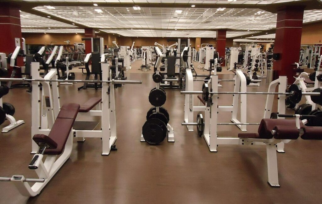 Modern gym facility with weight equipment — relates to business consulting for fitness industry leadership development.